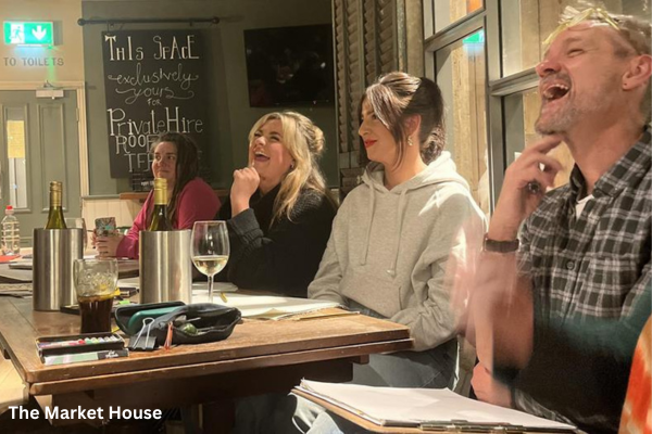 The Market House people laughing around table