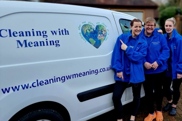 Kelly Moore and team standing next to branded Cleaning with Meaning van